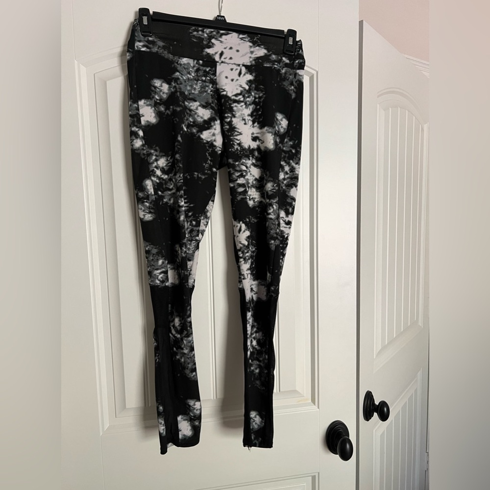 Like new black, white and gray leggings with mesh accents!